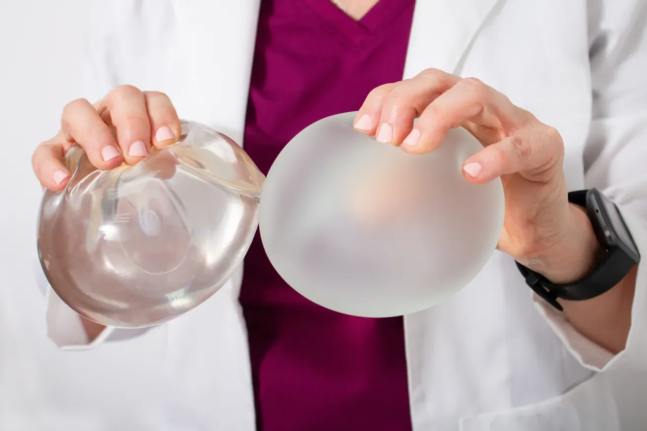 Plastic surgeon comparing breast implants