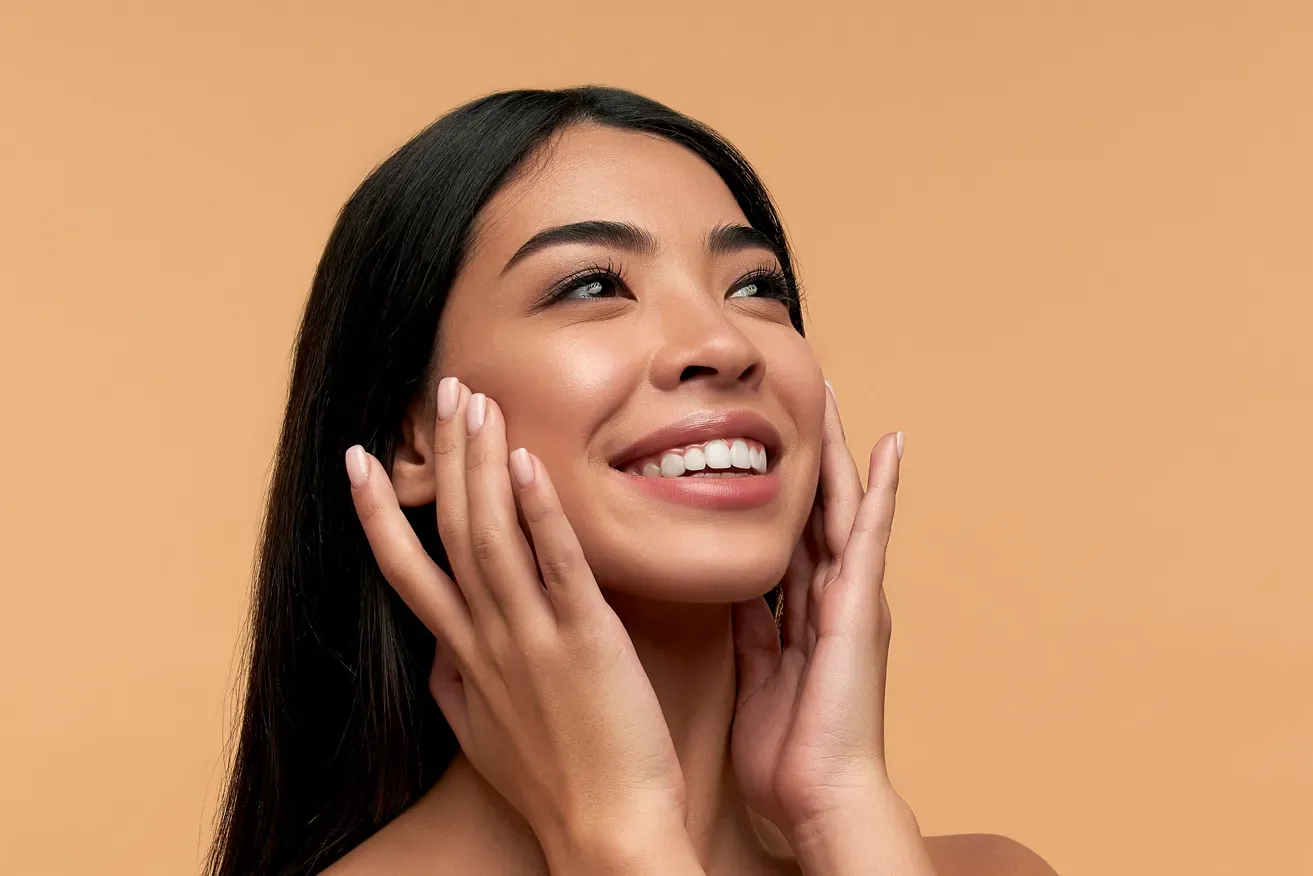 Young Asian woman happy with her plastic surgery results