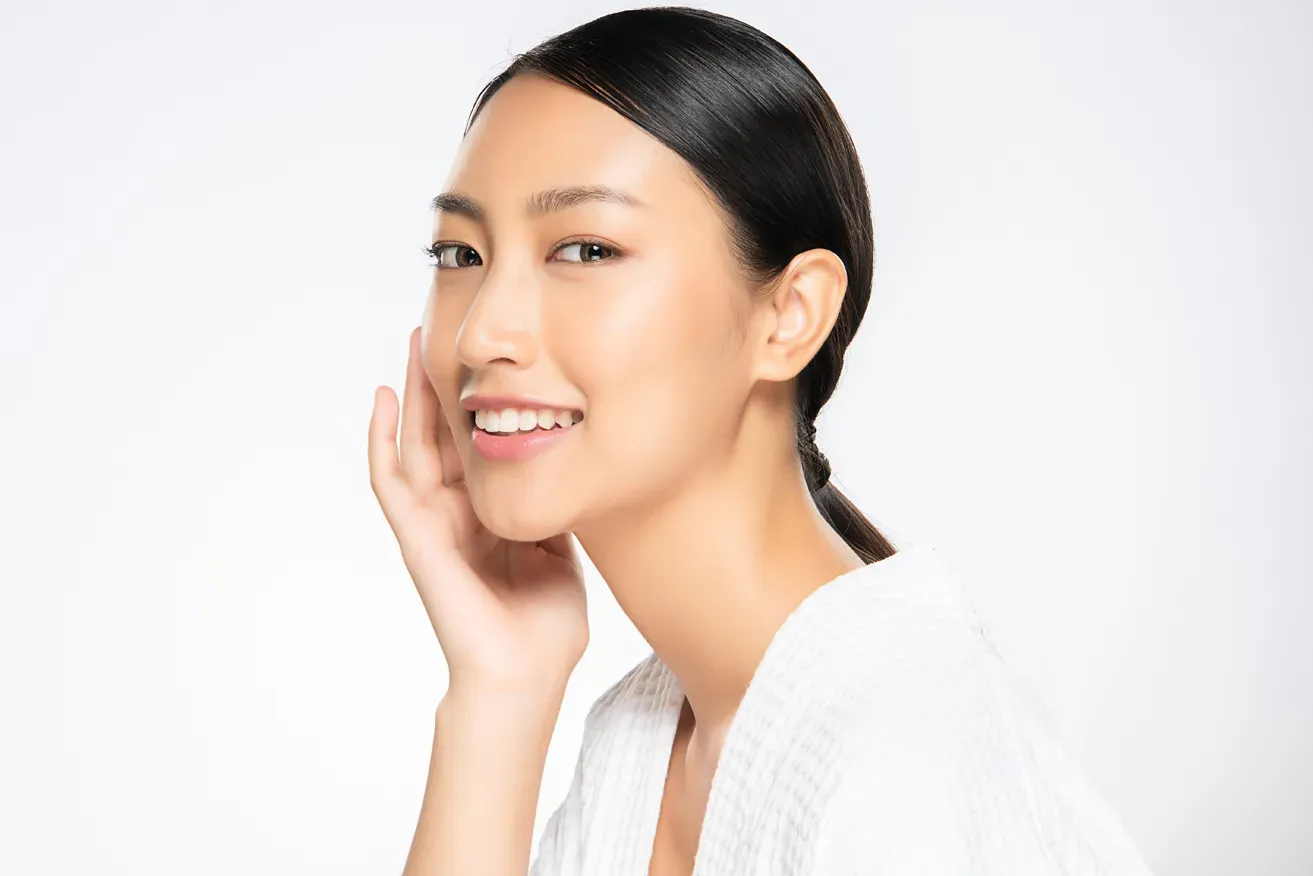 Close up of woman holding her face and smiling