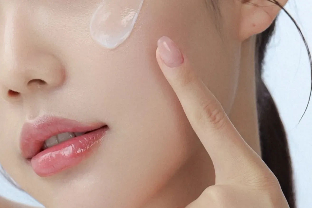 Woman applying skincare cream