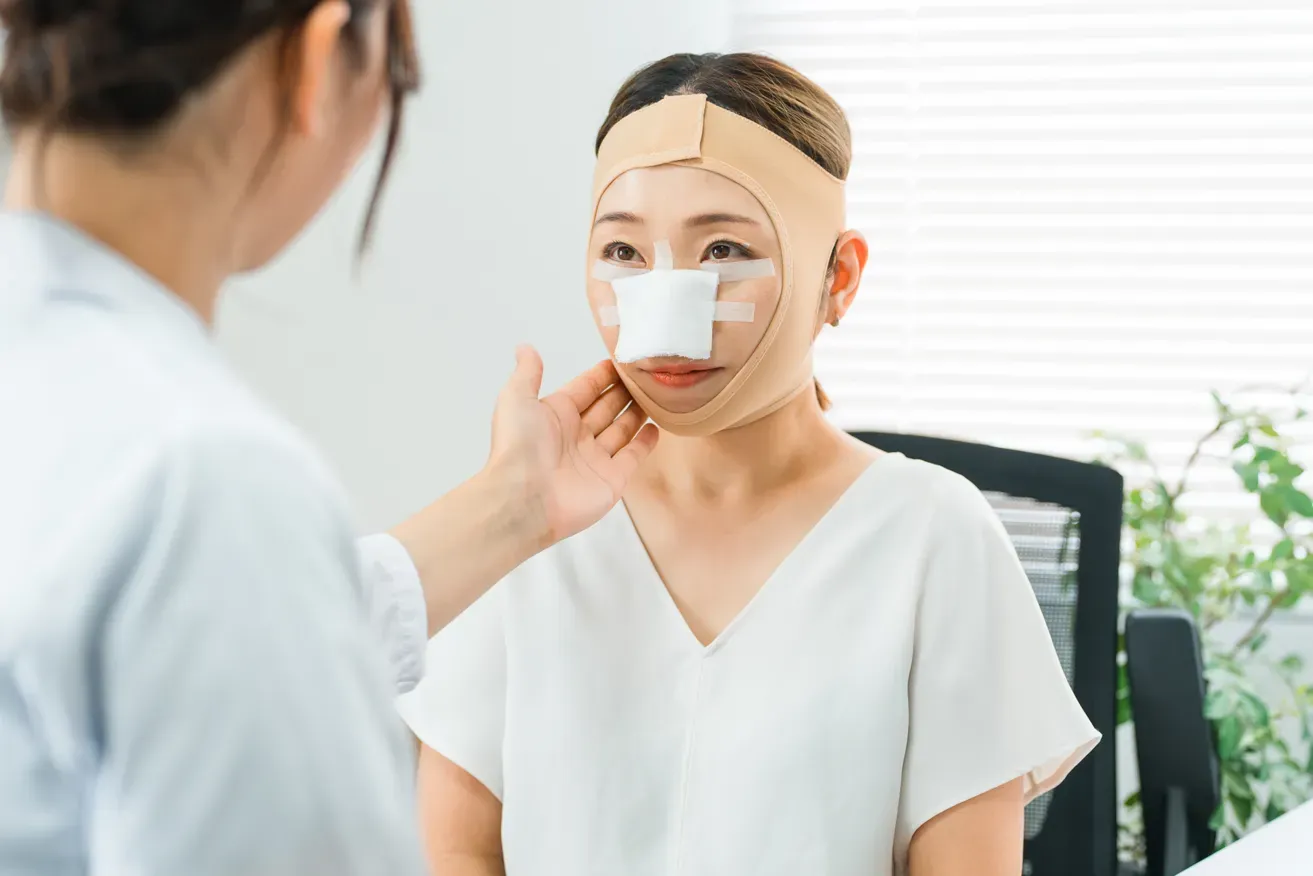 Plastic surgeon and patient having post-surgery consultation