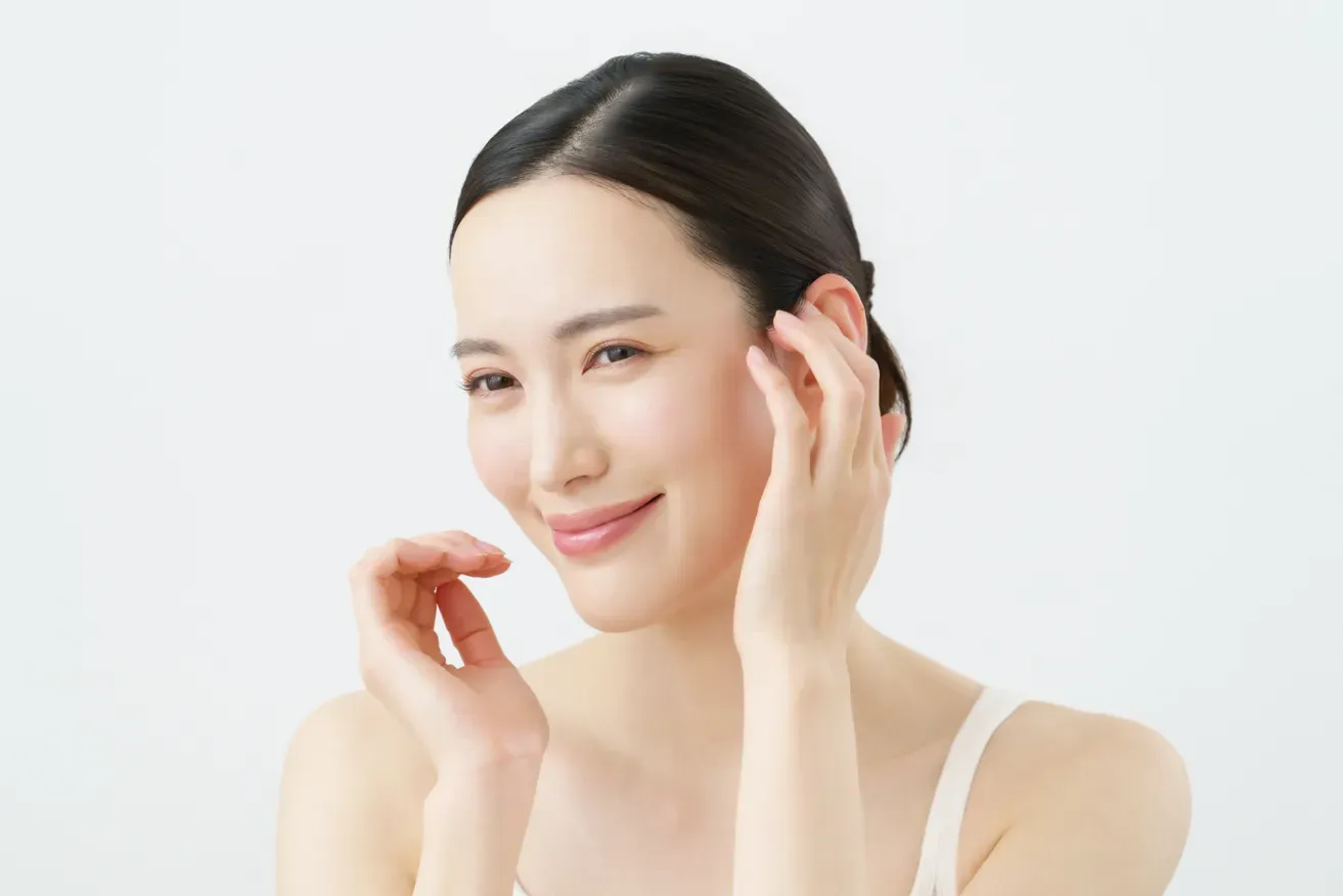 Woman smiling and touching her ear