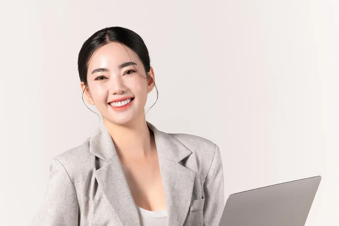 Smiling business woman holding laptop