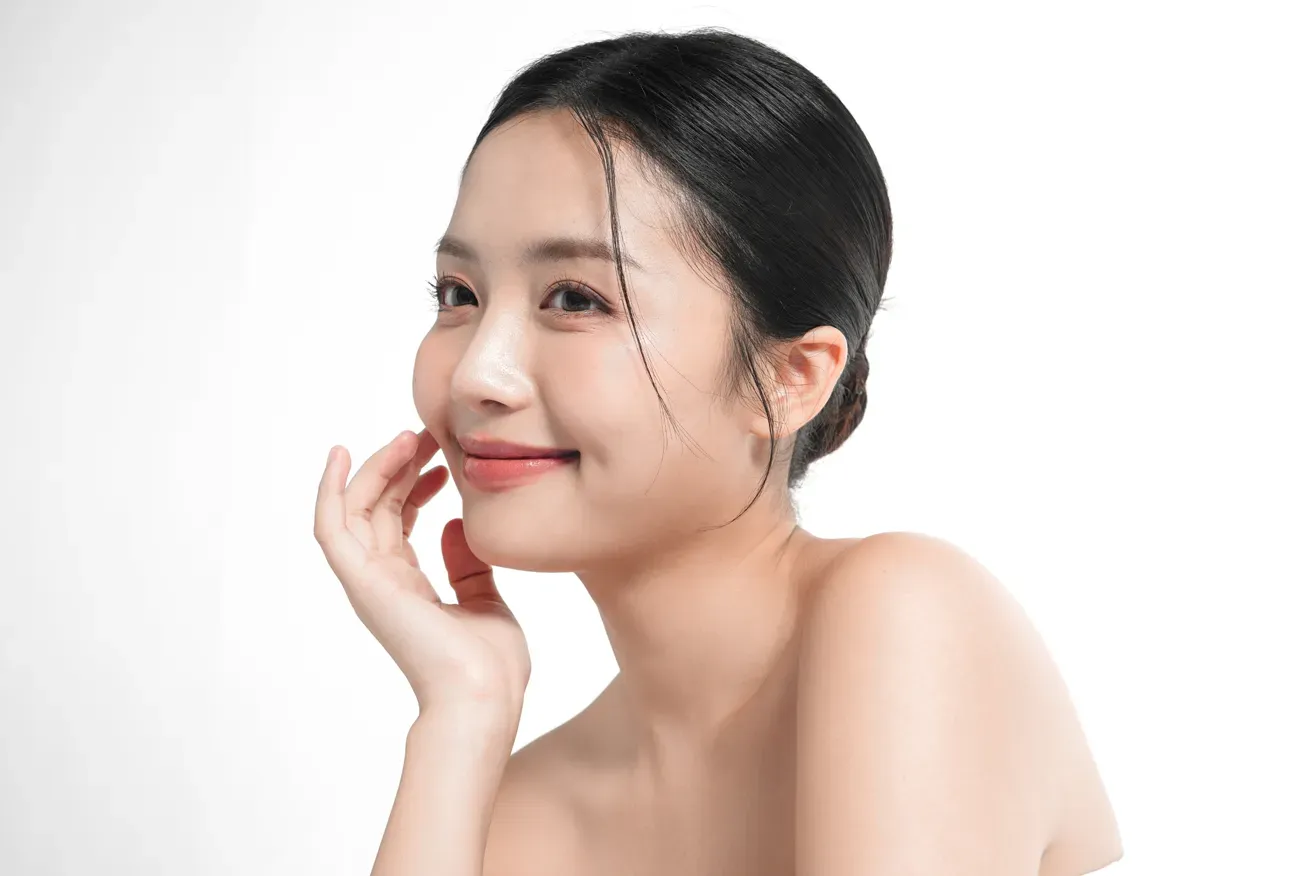 Confident woman smiling and touching her face
