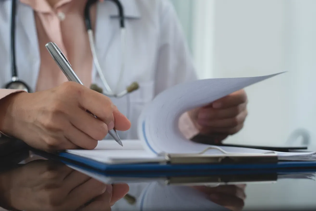 Surgeon reviewing medical notes on eyelid surgery