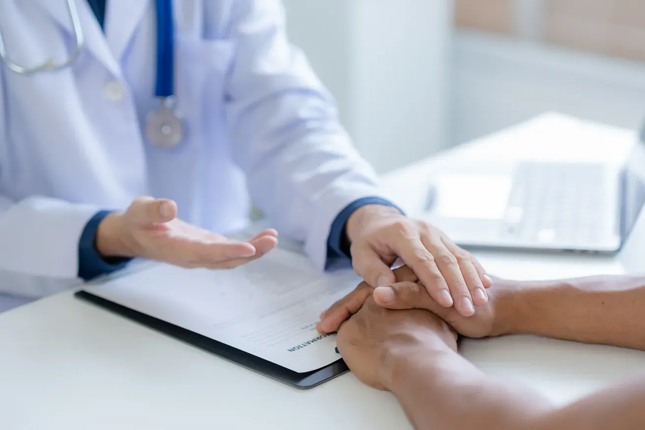 Plastic surgeon reassuring patient during consultation