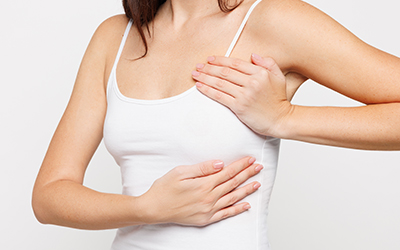 Close-up of a woman’s chest area, representing breast lift and body contouring changes.