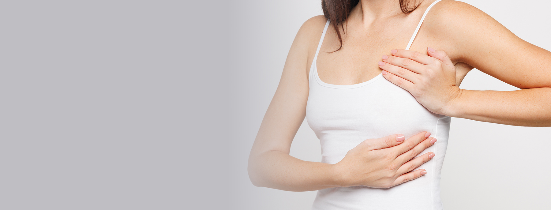 Close-up of a woman’s chest area, representing breast lift and body contouring changes.