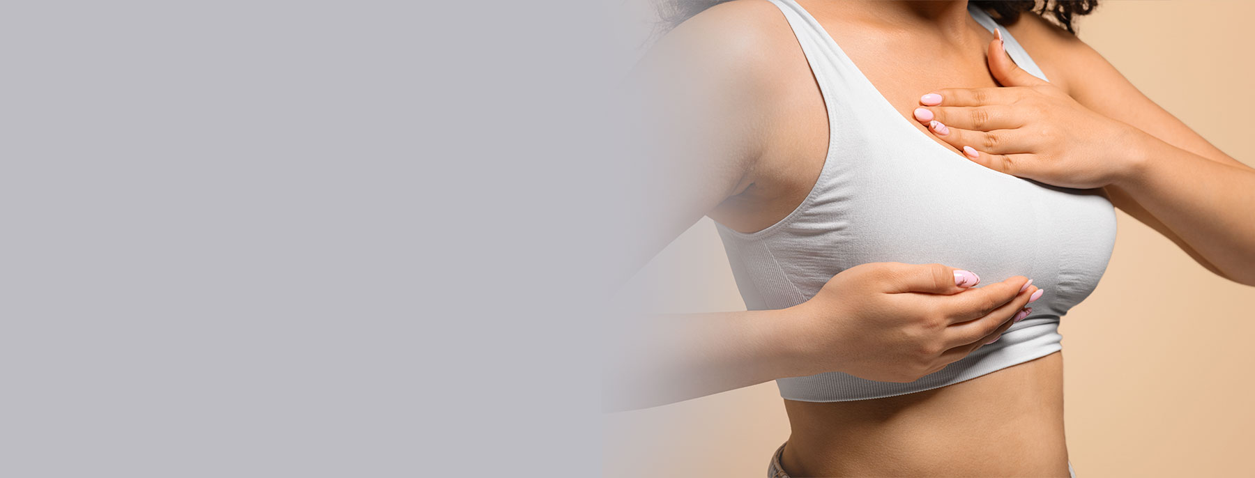 Woman gesturing to chest area representing considerations surrounding breast reduction surgery.