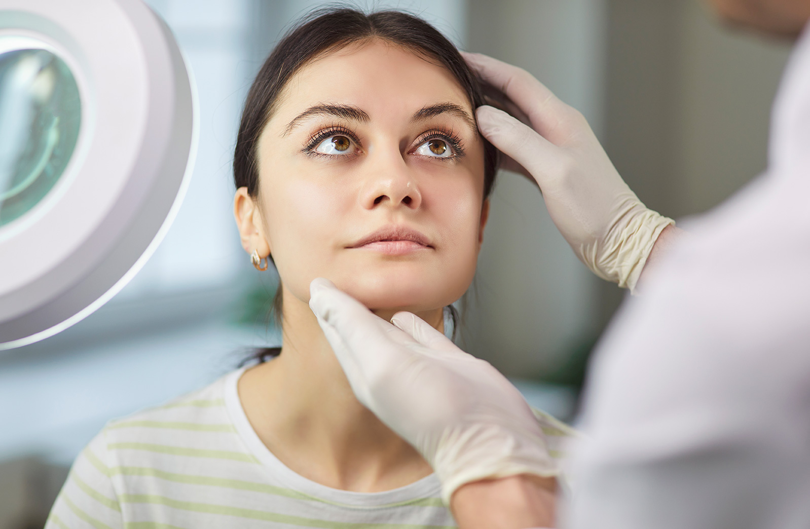 Patient discussing rhinoplasty goals with a plastic surgeon during a consultation.