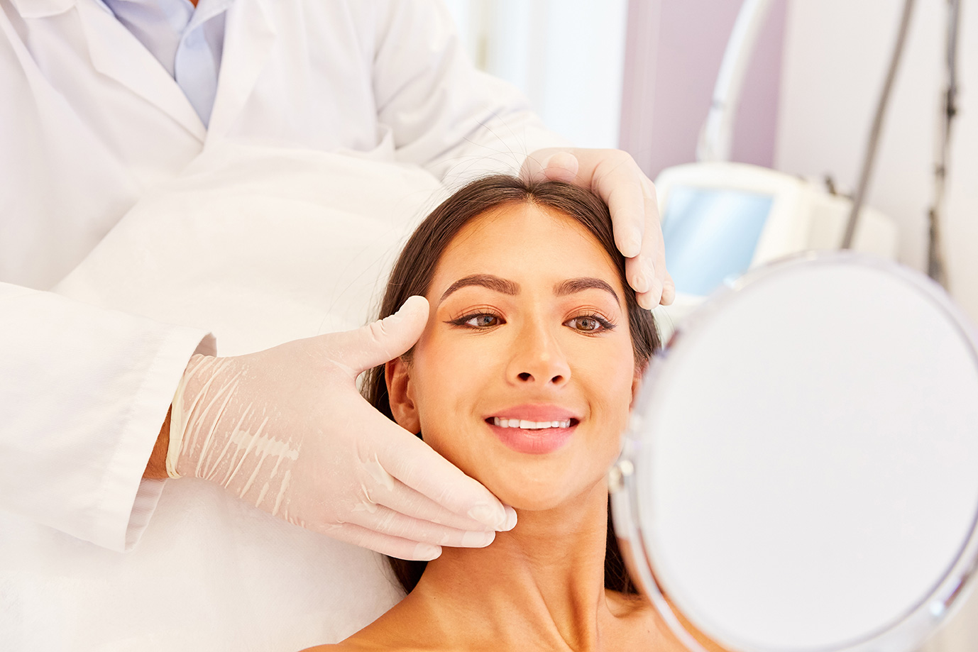 Plastic surgeon discussing revision plastic surgery options with a patient.